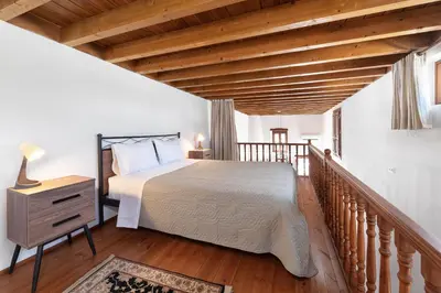 a bedroom with a bed and a wooden ceiling at Casa Porolithos in Malona Village