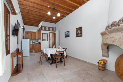 a kitchen and dining room with a table and chairs at Casa Porolithos in Malona Village