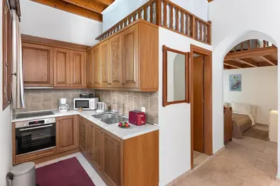 a kitchen with wooden cabinets and a counter top at Casa Porolithos in Malona Village