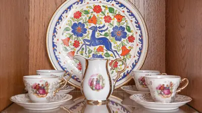 a vase on a shelf with cups and a plate at Casa Porolithos in Malona Village