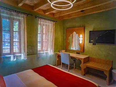 a bedroom with a desk and a bed and a table at Fabrizio del Carretto in Rhodes Town