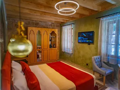 a bedroom with a large bed and a chair at Fabrizio del Carretto in Rhodes Town