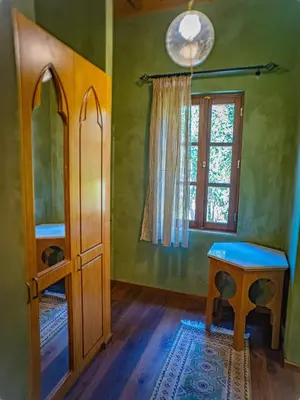a room with green walls and a table and a window at Fabrizio del Carretto in Rhodes Town
