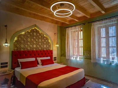 a bedroom with a bed with a red headboard and windows at Fabrizio del Carretto in Rhodes Town