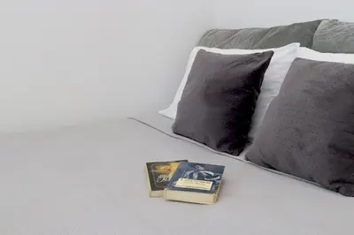 a book sitting on top of a bed with pillows at Casa Metropolis in Rhodes Town