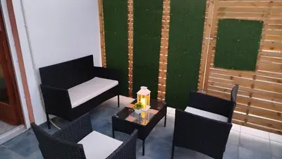 a patio with chairs and a table with a candle at SteMaMaisonette in Afantou