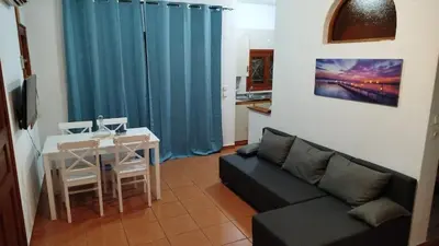 a living room with a couch and a table at SteMaMaisonette in Afantou