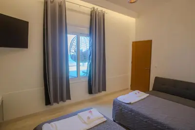 a living room with a couch and a window at Aegean Sunset Loft in Rhodes Town