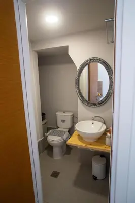 a bathroom with a sink and a toilet and a mirror at Aegean Sunset Loft in Rhodes Town