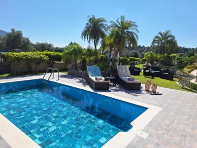 a swimming pool with two lounge chairs in a yard at Villa Maria in Haraki