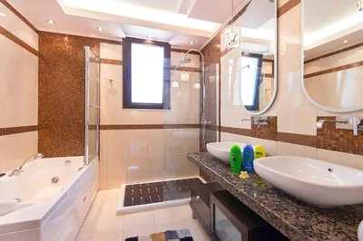a bathroom with a tub and a sink and a tubermott at Villa Maria in Haraki