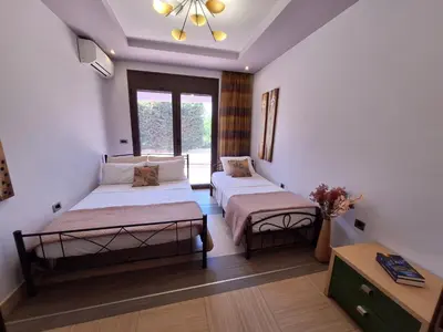 a bedroom with two beds and a window at Villa Maria in Haraki