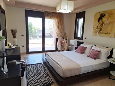 a bedroom with a large bed and a large window at Villa Maria in Haraki
