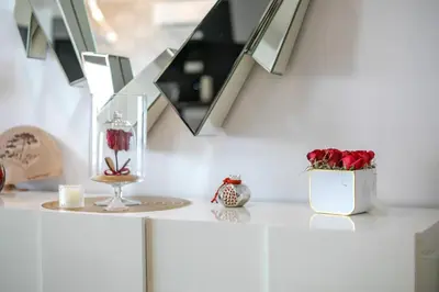 a white counter with a vase with roses in it at Coastal Mirage Sunset Reverie Luxury Seaview Apartment in Rhodes Town