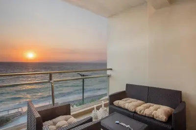 a living room with a view of the ocean at Coastal Mirage Sunset Reverie Luxury Seaview Apartment in Rhodes Town