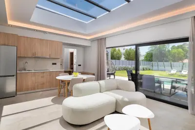 a kitchen and living room with a skylight at Sunrays Pool Villas in Kalathos
