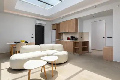 a living room with white furniture and a skylight at Sunrays Pool Villas in Kalathos