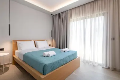 a bedroom with a bed with towels on it at Sunrays Pool Villas in Kalathos