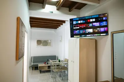 a room with a table and a tv on the wall at Rhodes Central Studio by the sea in Rhodes Town