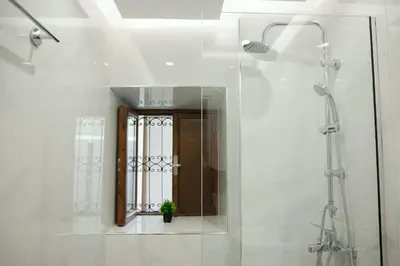 a bathroom with a shower with a mirror and a window at Rhodes Central Studio by the sea in Rhodes Town