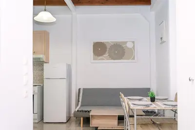 a kitchen with a table and a couch in a room at Rhodes Central Studio by the sea in Rhodes Town