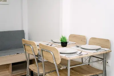 a dining room table with chairs and plates on it at Rhodes Central Studio by the sea in Rhodes Town