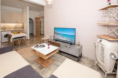 a living room with a flat screen tv on a wall at Steno Loft Suite in Rhodes Town