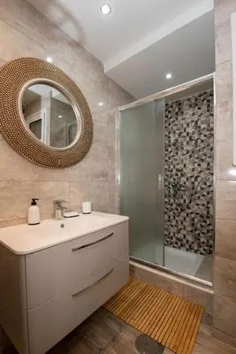 a bathroom with a sink and a shower with a mirror at Steno Loft Suite in Rhodes Town