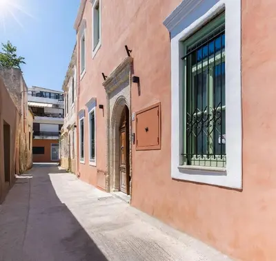 an alley in an old building with a window at Steno Loft Suite in Rhodes Town