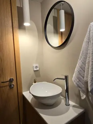 a bathroom with a white sink and a mirror at Pension Zoi Luxury Room in Kolimbia