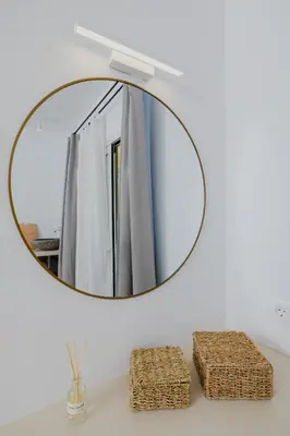 a mirror on a wall above a bathroom sink at Pension Zoi Luxury Room in Kolimbia