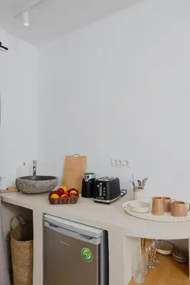 a kitchen with a counter top with a refrigerator at Pension Zoi Luxury Room in Kolimbia
