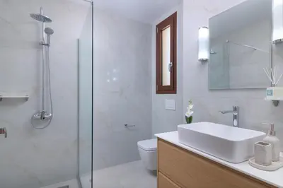 a bathroom with a sink and a glass shower at Ninalma Villa in Kalavárda