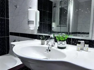 a bathroom with a sink with two plants on it at No Nono in Ialyssos