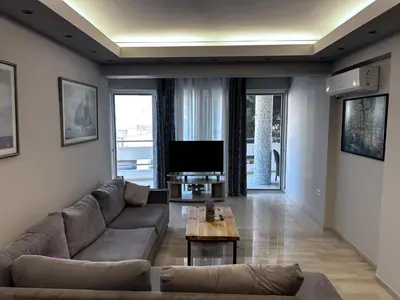 a living room with a couch and a tv at No Nono in Ialyssos