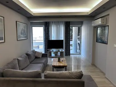 a living room with a couch and a tv at No Nono in Ialyssos