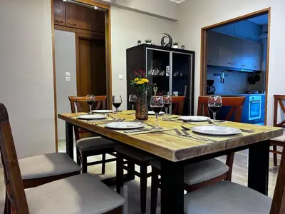 a dining room table with wine glasses and chairs at No Nono in Ialyssos