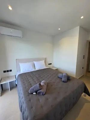 a bedroom with a large bed with two stuffed animals on it at AleGo Casa in Rhodes Town