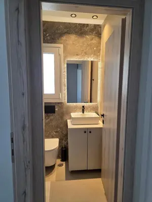a bathroom with a sink and a toilet and a mirror at AleGo Casa in Rhodes Town