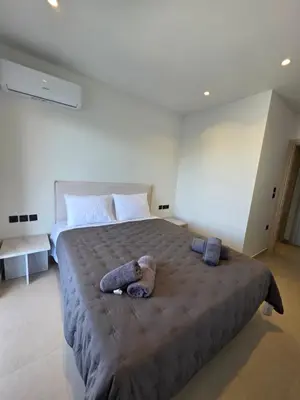 a large bed with a teddy bear laying on it at AleGo Casa in Rhodes Town