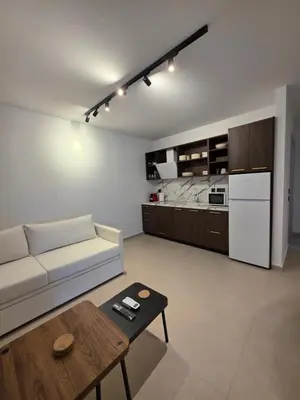 a living room with a white couch and a table at AleGo Casa in Rhodes Town