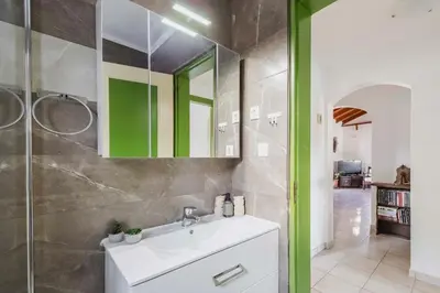 a bathroom with a sink and a mirror at Villa Angelina in Afantou