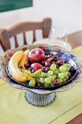 a glass bowl of fruit on a table at Villa Angelina in Afantou