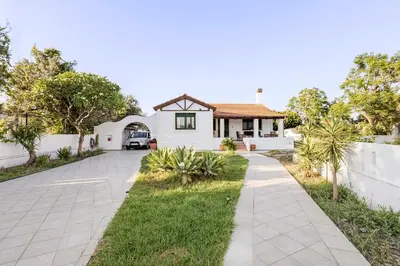 a house with a white fence and a driveway at Villa Angelina in Afantou