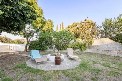 two chairs and a table in a yard at Villa Angelina in Afantou