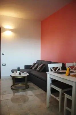 a living room with a couch and a table at Anemomilos View in Koskinou