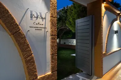a door in the side of a building at Duo Verde Celine Garden Apartment in Kremasti