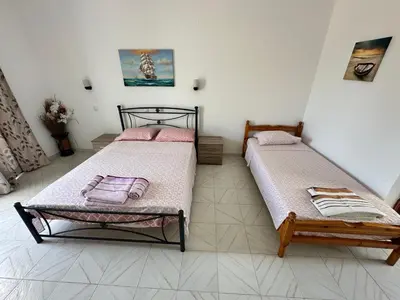 two beds sitting in a room with at My Agathi Studios in Haraki