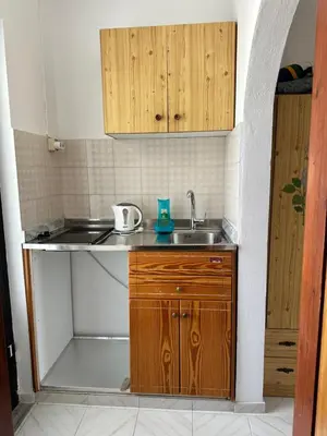 a small kitchen with a sink and a counter at My Agathi Studios in Haraki