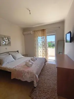 a bedroom with a bed with two towels on it at Villa Agapi in Pastida